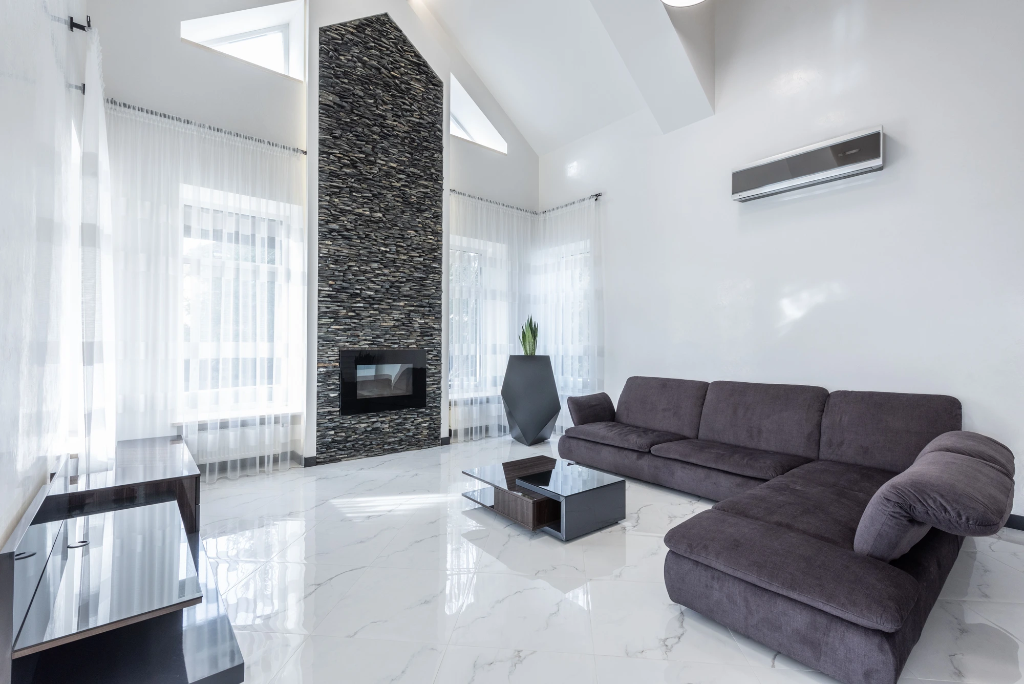 Bright modern living room with a wall-mounted air conditioner